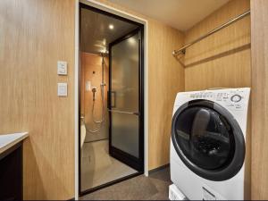 a washing machine in a bathroom with a shower at MIMARU Kyoto Shinmachi Sanjo in Kyoto