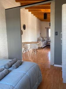 a room with a bed and a table and a couch at Departamento vista de montaña in Las Heras