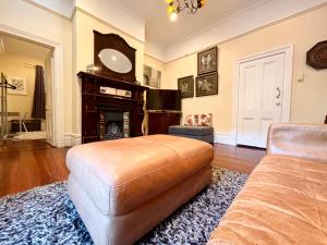 a living room with a couch and a fireplace at Subiaco 1bd In Heritage Home Gem in Perth