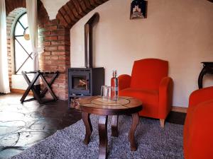 a living room with a chair and a wood stove at Hacienda Jimenita Wildlife Reserve in Puembo