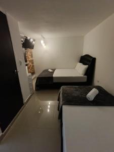 Rúm í herbergi á Hotel Coffee Real Pereira