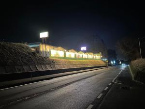 an empty street at night with a building with lights at ホテルZERO in Tanigashira +2 photos