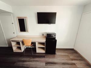 a room with a desk and a television on a wall at Motel 6-Holbrook, AZ in Holbrook