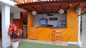 a kitchen with a bar in a house at Hotel Sol y Playa Montañita in Montañita