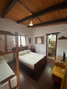 a bedroom with two bunk beds and a desk at Hostal Tierra Andina Cafayate in Cafayate