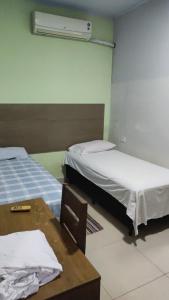 เตียงในห้องที่ Pousada ji Paraná