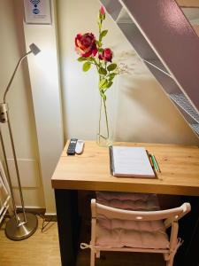 a desk with a vase with a flower on it at MADRID CENTRO II in Madrid