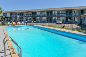 a large swimming pool in front of a building at Canadas Best Value Inn St. Catharines in St. Catharines