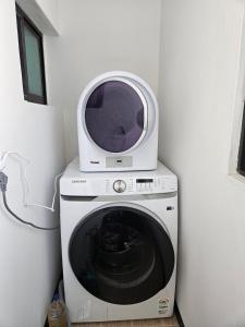 a microwave sitting on top of a washing machine at Gyeongju happy house in Gyeongju +3 photos