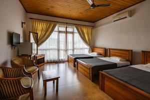 a hotel room with two beds and a tv at Alta Vista in Ella +29 photos