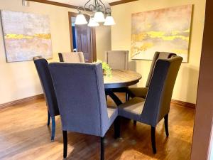 a dining room with a table and chairs at Lake House and Studio Book Two places in one 4 bedrooms large driveway and yard in Rogers
