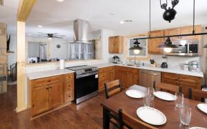 a kitchen with wooden cabinets and a table with chairs at Big Oak Hideaway in Gatlinburg