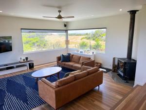 a living room with a couch and a table at Martyrs Lookout - Luxury Accommodation in Peterborough