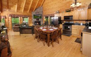 a kitchen with a table and chairs and a stove at Simply Amazing in Pigeon Forge