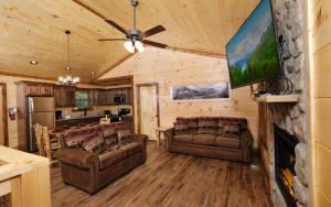 a living room with two couches and a kitchen at Wine Not in Gatlinburg