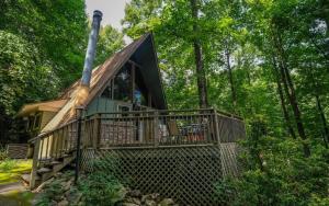 a cabin in the woods with a large deck at Shepherds Crook 1127 in Gatlinburg