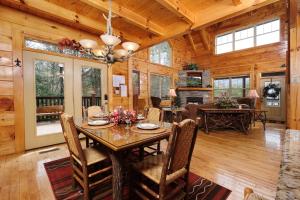 a dining room with a table and chairs in a cabin at Hemlock Ridge 1713 in Gatlinburg
