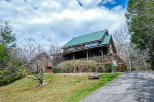 a large wooden house with a green roof at Hemlock Ridge 1713 in Gatlinburg