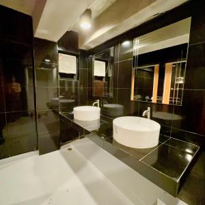 a bathroom with two sinks and a mirror at Noc House in Bang Khlo