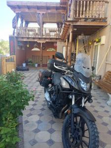 a motorcycle parked in front of a building at Guest House Dilorom in Khiva