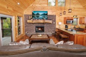 a living room with a couch and a fireplace at Swept Away in Gatlinburg