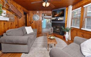 a living room with two couches and a fireplace at River Romance in Gatlinburg +18 photos