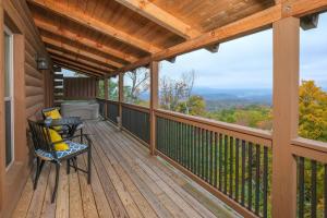 a deck with a table and chairs on it at Swept Away in Gatlinburg