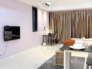 ペタリンジャヤにあるThe Zesty Icon City Petaling Jayaの壁にテレビとベッドが備わる客室です。
