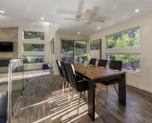 a dining room with a wooden table and chairs at A Pear Tree Loft in Bright