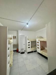 a room with multiple bunk beds in a room with a tile floor at La Oviedo Villas Resort Boracay in Boracay