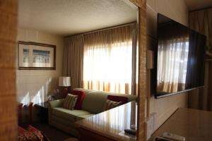 a living room with a couch and a window at Arcadia Hotel in Gering