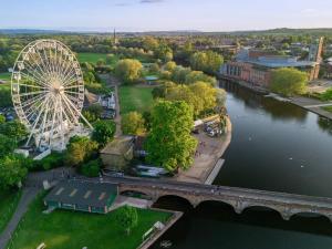 an aerial view of a ferris wheel next to a river at The Annex, Stratford Upon-Avon in Stratford-upon-Avon