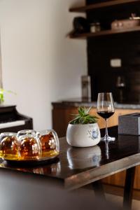 a table with a glass of wine and a plant at Mật Pet Farm - Mộc Châu in Mộc Châu