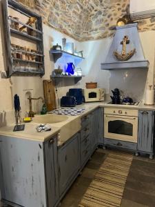 a kitchen with white cabinets and a stove top oven at Byzantine Home in the Castle in Mestá