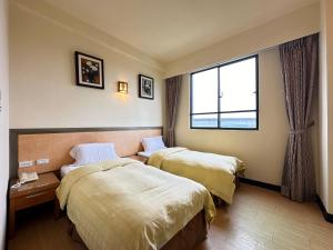 Postel nebo postele na pokoji v ubytování CHIENTAN Youth Hotel