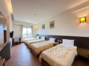 Postel nebo postele na pokoji v ubytování CHIENTAN Youth Hotel