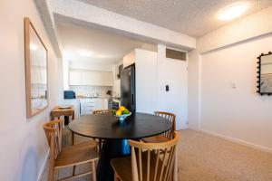 a kitchen and dining room with a table and chairs at Skyline and Riverview 2 bedrooms apartment in Brisbane