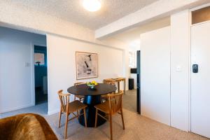a dining room with a table and chairs at Skyline and Riverview 2 bedrooms apartment in Brisbane