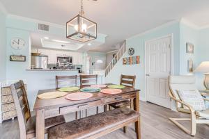 a kitchen and dining room with a wooden table and chairs at Bayfront Kontiki in Rockport