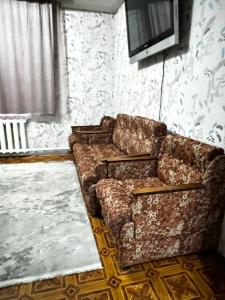 a living room with a couch and a tv at Тимур in Bishkek
