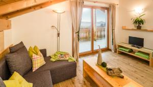 a living room with a couch and a tv at Mandlerhof in Verano