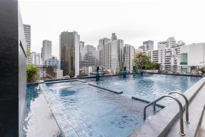 a swimming pool on top of a building with a city skyline at Admiral Premier Bangkok in Bangkok