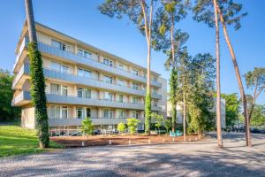 an exterior view of a hotel with palm trees at Waldhotel in Mainz