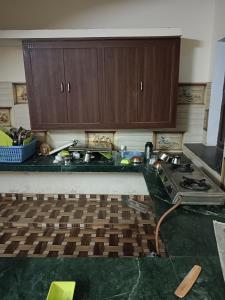 a kitchen with a stove and a counter top at Mahadev Kripa sadan Homestay & Guest house in Ayodhya