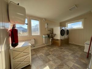a bathroom with a sink and a washing machine at Oppmyre Camping in Myre