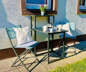 a table and two chairs next to a table with a table and a table at Sweet Mountain Home in Bad Bleiberg