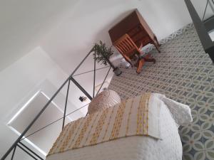 a living room with a bed and a glass railing at Loft A1 Casa Catedral in Guadalajara