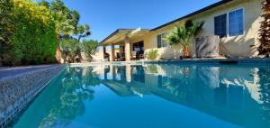a swimming pool in front of a house at Make Your Friends Jealous! in Indio
