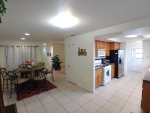 a kitchen and dining room with a table and refrigerator at Make Your Friends Jealous! in Indio