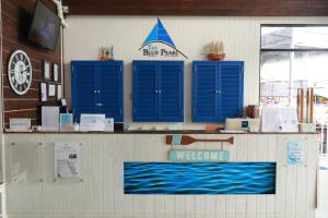 a counter with blue shutters on a boat at The Blue Pearl Kata Hotel in Kata Beach